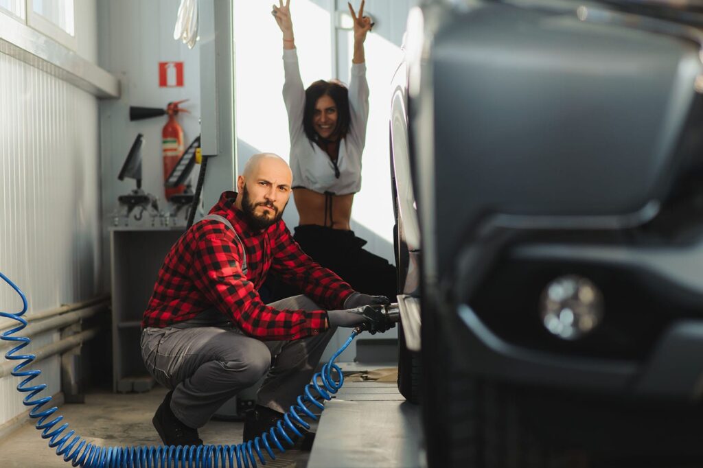 man-repairing-a-car-wheel-in-a-garagec-min